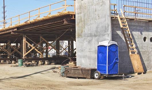 porta potties stacked at a busy work site